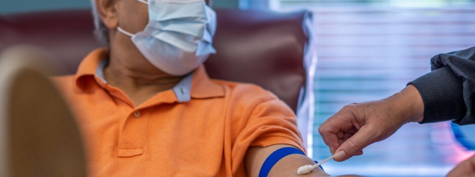 Older Man In Mask Getting Arm Swabbed