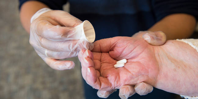 nurse measures medications at InnovAge PACE