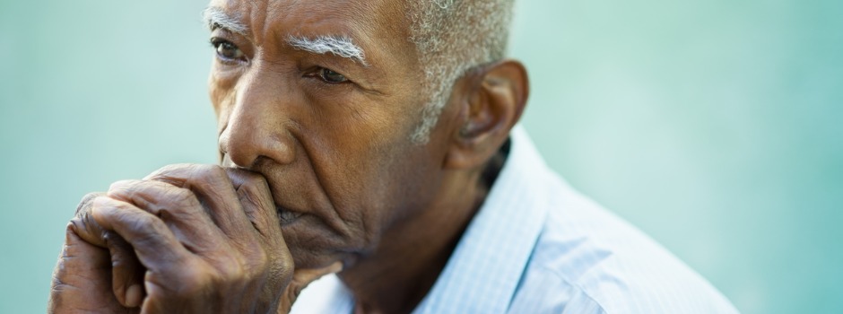 Older Man With Hands Folded Around Mouth