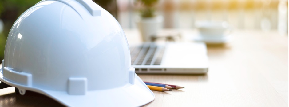 Construction Hat On Desk Beside Pencils