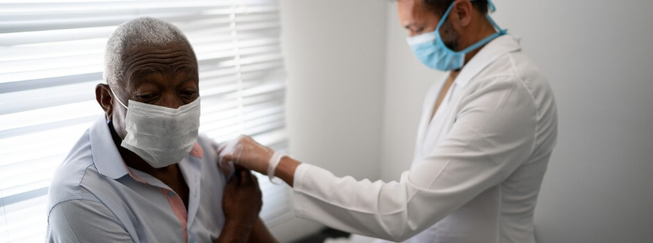 Healthcare Worker Administering Flu Shot To Older Adult