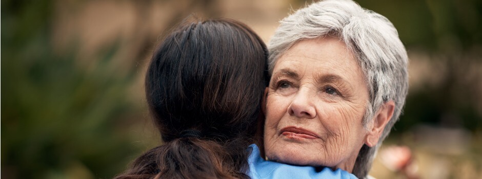 Young Woman Embracing Older Woman In A Hug