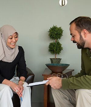 InnovAge employee and caregiver discussing a case