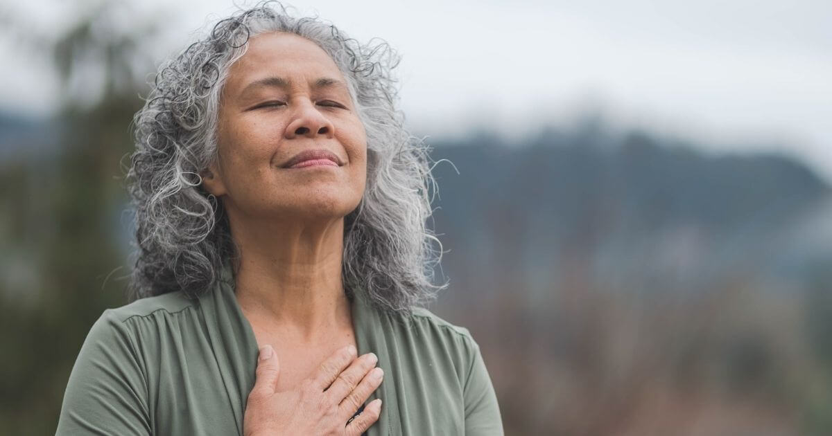 Older Adult Taking A Deep Breath With Right Hand On Chest