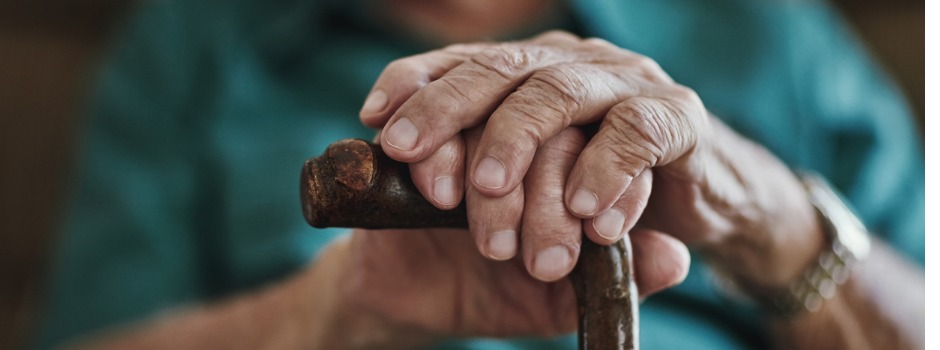 Senior Hands Rest On Cane