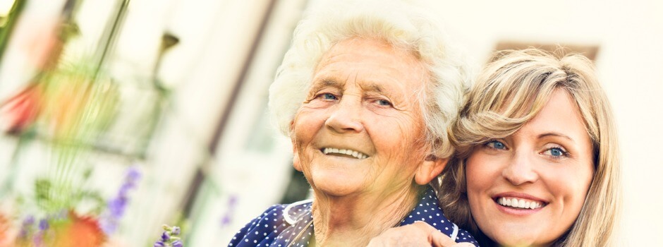 Family Caregiver Hugging Her Care Recipient; They Are Both Smiling